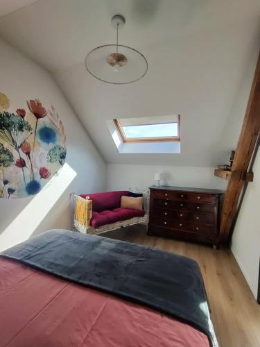 a attic bedroom with a bed and a couch at Appartement Cosy in Sausheim