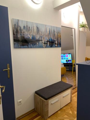 a room with a bench and a painting on the wall at Small but Charming-Yellow Appartement in Baden