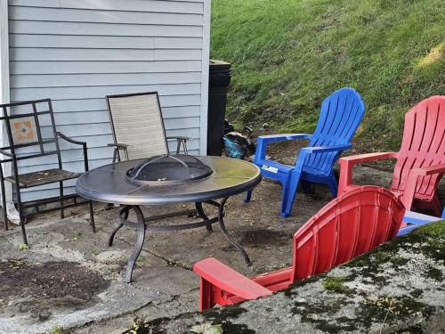 a group of chairs and a table with a fire pit at Indian Lake House in Worcester