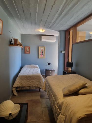 a bedroom with two beds in a room at casa del lago -villa carlos paz in Villa Carlos Paz