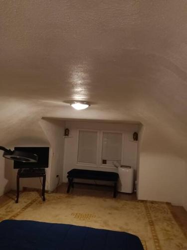 a living room with a piano and a room with a bed at Indian Lake House in Worcester