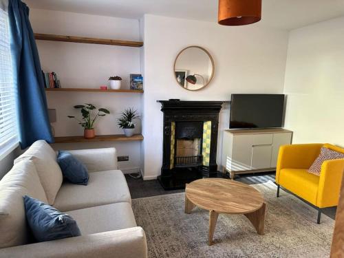a living room with a couch and a fire place at Revamped Holywood town centre house in Holywood