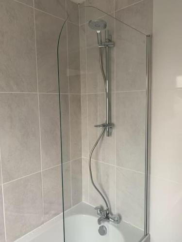 a shower with a glass door in a bathroom at Revamped Holywood town centre house in Holywood
