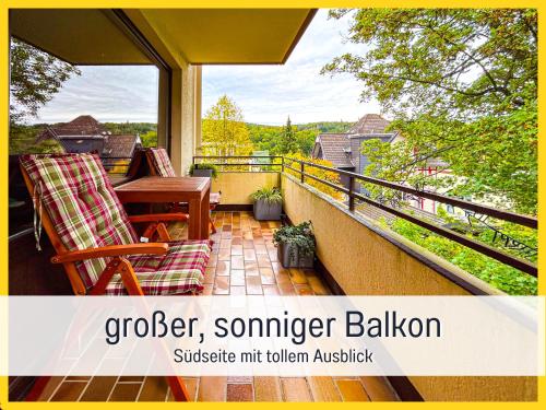 a balcony with a table and chairs and a view at HaFe Ferienwohnung Bad Sachsa - waldnah, hundefreundlich, Smart Home Ausstattung in Bad Sachsa