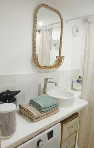 une salle de bain avec un lavabo et un miroir sur un comptoir dans l'établissement Studio climatisé au calme au coeur du village médiéval avec rue piétonne, à Cagnes-sur-Mer