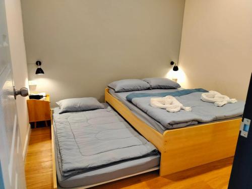 two beds in a room with towels on them at COZY HOME @BETONG in Betong