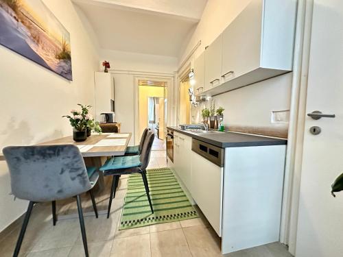 a kitchen with a table and chairs in a room at Ferienwohnung Marion Klagenfurt zentrumsnähe in Klagenfurt