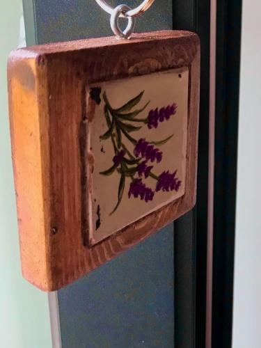a wooden bird house with a flower painted on it at Quinta de São Francisco Houses in Viseu