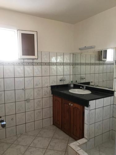 a bathroom with a sink and a mirror at villa soleil in Mirleft