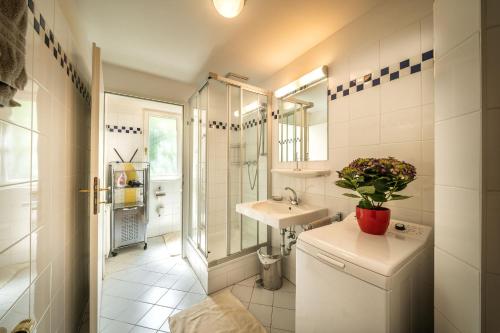 a white bathroom with a sink and a toilet at Schlossquadrat Apartement 14 A in Vienna