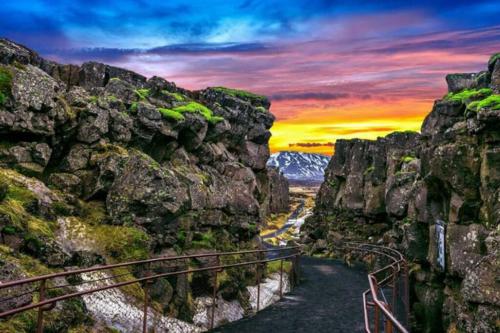 a view of a canyon with a sunset in the background at Greenhouse Golden Circle Villa in Reykholt