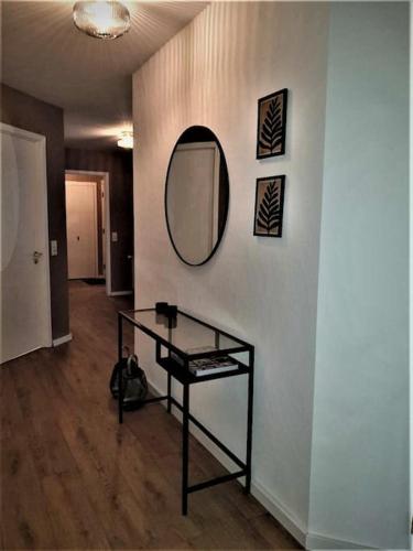 a room with a table and a mirror on a wall at Greenhouse Golden Circle Villa in Reykholt