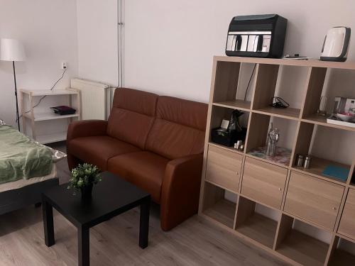a living room with a couch and a book shelf at Assad and Naveera, Steekkant 40 in Barendrecht