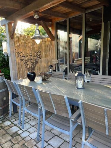 a wooden table and chairs on a patio at Casa Fuori in Oirschot