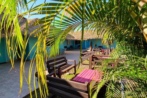 a row of benches in front of a building at Hotel & Apartments "CHEZ HIVA" in Hanga Roa