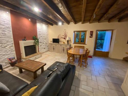 a living room with a couch and a table at La maison paisible in Guéméné-Penfao