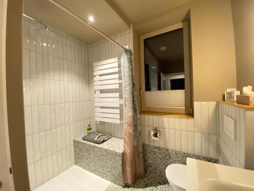 a bathroom with a shower and a sink and a mirror at copper beech place in Achim