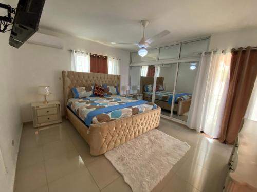 a bedroom with a large bed and a mirror at Santiago City Center Huge nice Apartment to stay rooftop to enjoy the city view in Santiago de los Caballeros