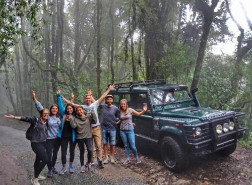 a group of people standing in front of a jeep at A3A Oastel CoLiving in Tanah Rata