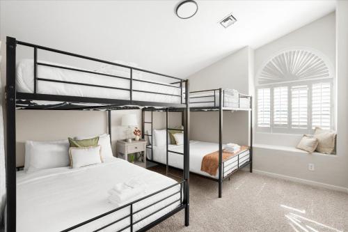a bedroom with two bunk beds and a window at The Elysian Escape in Phoenix