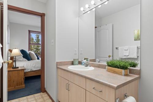 a bathroom with a sink and a large mirror at Silver Peaks in Silver Star