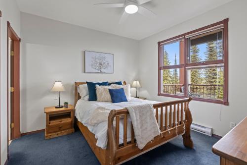 a bedroom with a bed and a window at Silver Peaks in Silver Star