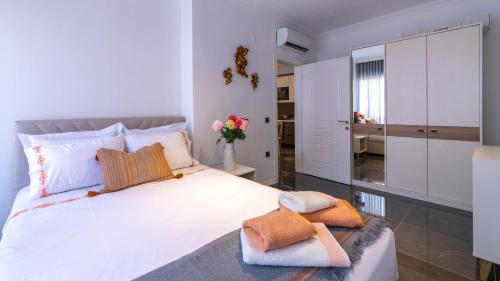 a bedroom with a large white bed with towels on it at Deluxe Marine House in Marmaris