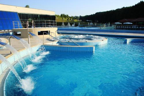 a water slide in a swimming pool next to a building at HOTEL Bioterme Mala Nedelja in Ljutomer