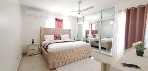 a bedroom with a bed and a mirror at Santiago City Center Huge nice Apartment to stay rooftop to enjoy the city view in Santiago de los Caballeros
