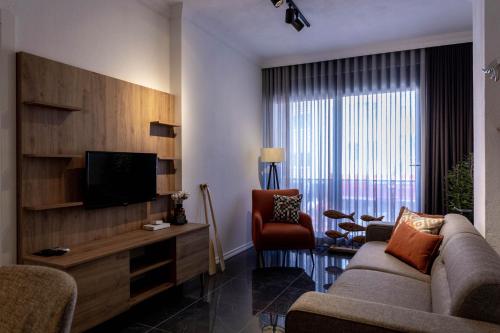 a living room with a couch and a television at Deluxe Marine House in Marmaris