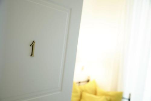 a door with a yellow couch next to a window at Affittacamere Arosio in Monza