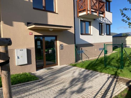 a walkway leading to a building with a door at Apartmán 696 Pod Ještědem in Liberec