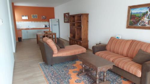 a living room with two couches and a table at ORQUIDEA in Irapuato