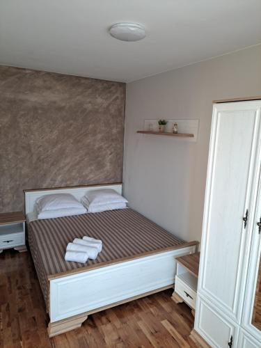 a bedroom with a bed with towels on it at Megi Apartments, Nesebar sity in Nesebar