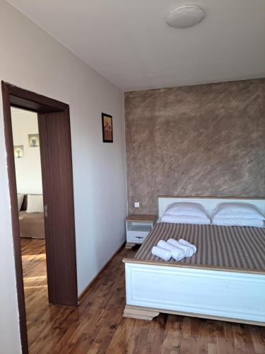 a bedroom with a bed with two towels on it at Megi Apartments, Nesebar sity in Nesebar