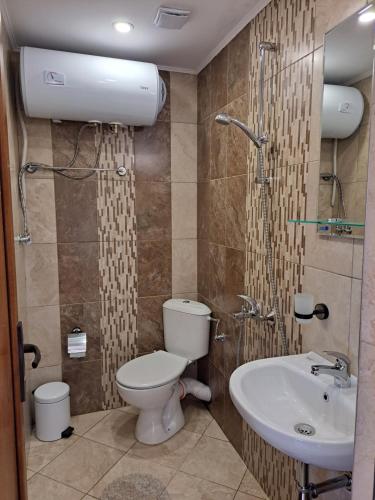 a bathroom with a toilet and a sink at Megi Apartments, Nesebar sity in Nesebar
