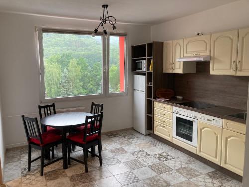 a kitchen with a table and chairs and a window at U KOSMONAUTA in Děčín