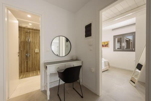 a bathroom with a sink and a mirror and a shower at Villa Isterni Paros in Isterni