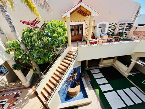 an aerial view of a house with a palm tree at Marisol Hotel Boutique in San José del Cabo