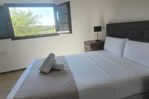 a bedroom with a bed with a remote control on it at Sabbia Suites Casa Malvasía in Mozaga