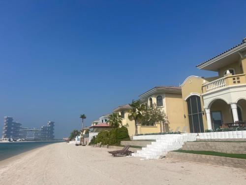 a house on the side of a road next to the ocean at The Atlantis Hotel View, Palm Family Villa, With Private Beach and Pool, BBQ, Front F in Dubai