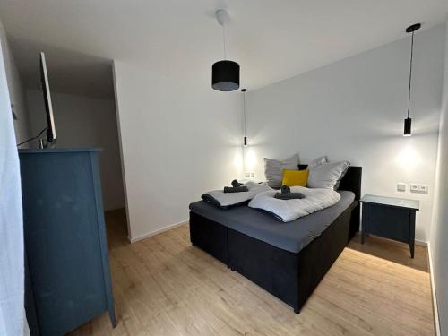 a bedroom with a bed with pillows on it at Modern, stylisch und zentral! in Meuselwitz