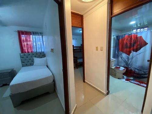 a small bedroom with a bed and a mirror at Santo Domingo Paradise V - #211 in La Estrella