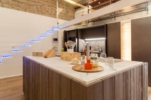 a kitchen with a large island in a room at un lusso ineguagliabile nel cuore di napoli in Naples