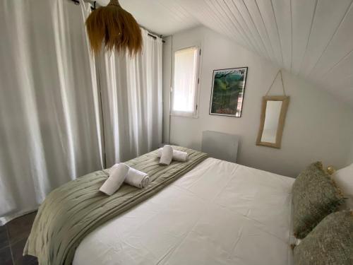 a bedroom with a large white bed with two pillows at La Kaz montagne in Briançon