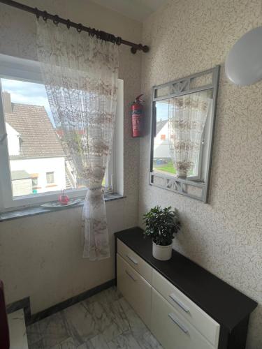 a room with a window with a dresser and a mirror at Wohnung in Herford in Herford