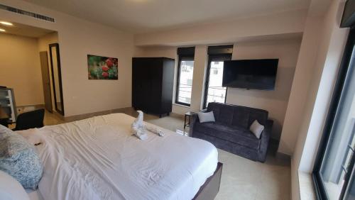 a bedroom with a bed with a stuffed animal on it at Mizirawi Historic Hotel in Ramallah