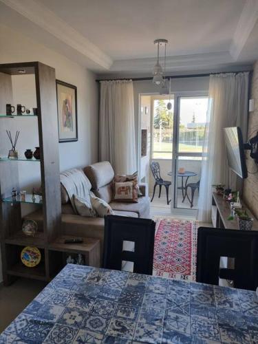 a living room with a couch and a table at Apto completo 2 quarto 2 banheiro universidade Positivo Volvo C garagem in Curitiba