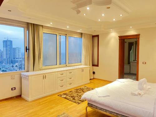 a bedroom with a bed and a large window at Luxury Villa By The Nile in Cairo