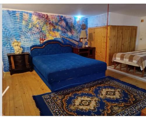 a bedroom with a blue bed with a map on the wall at Maravilja3 in Filmski Grad